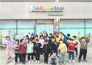 아이들이 예꿈지역아동센터 앞에서 찍은 단체사진입니다.